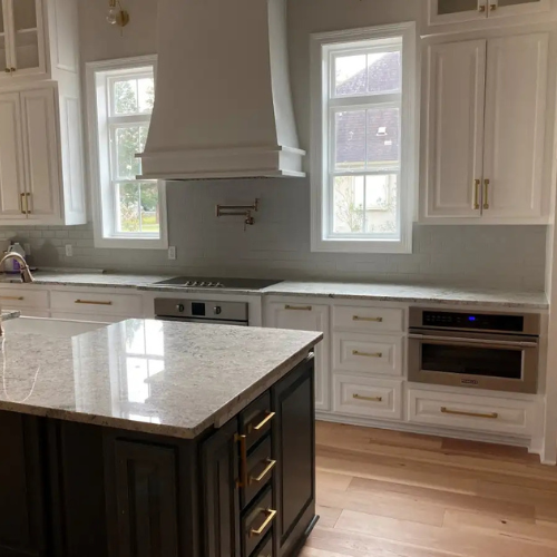 Kitchen with vinyl plank flooring and white cabinetry